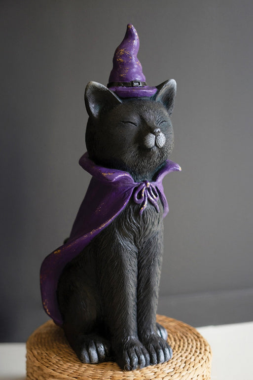 Kalalou Black cat figurine wearing a purple witch hat and scarf on a textured surface with a dark background