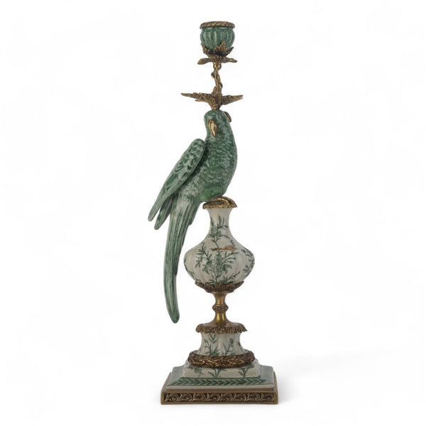 Decorative candle holder with a parrot on top against a white background