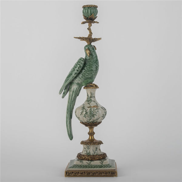 Decorative candle holder with a parrot figure on a gray background