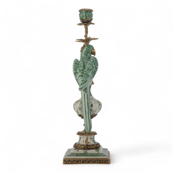 Decorative candle holder with parrot design on a white background