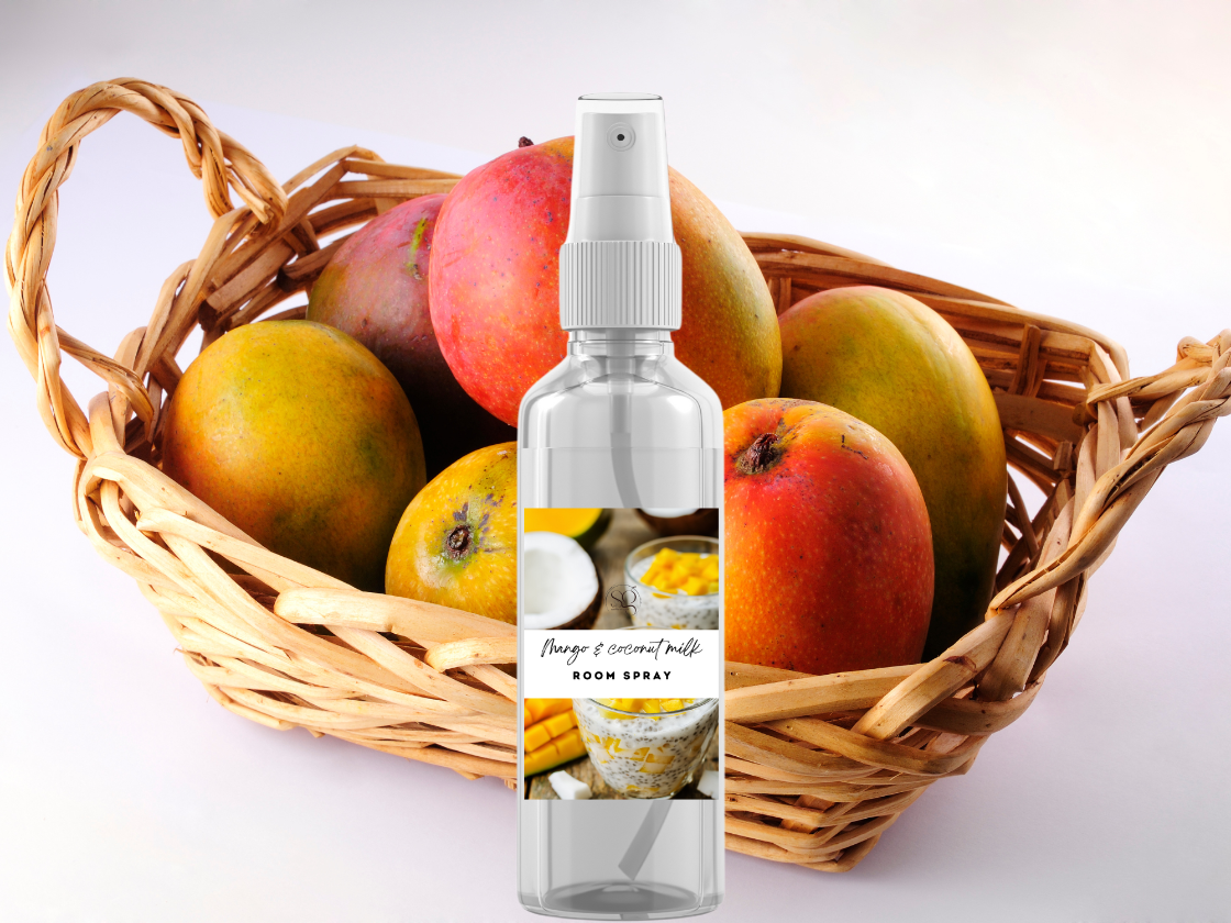 Room spray bottle with mangoes in a basket on a white background