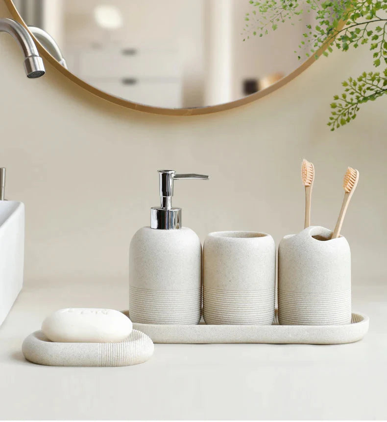 Beige 5Pcs Bathroom Accessories set by Buddify with soap dispenser, tumbler, toothbrush holder, and soap dish on tray in bathroom setting.