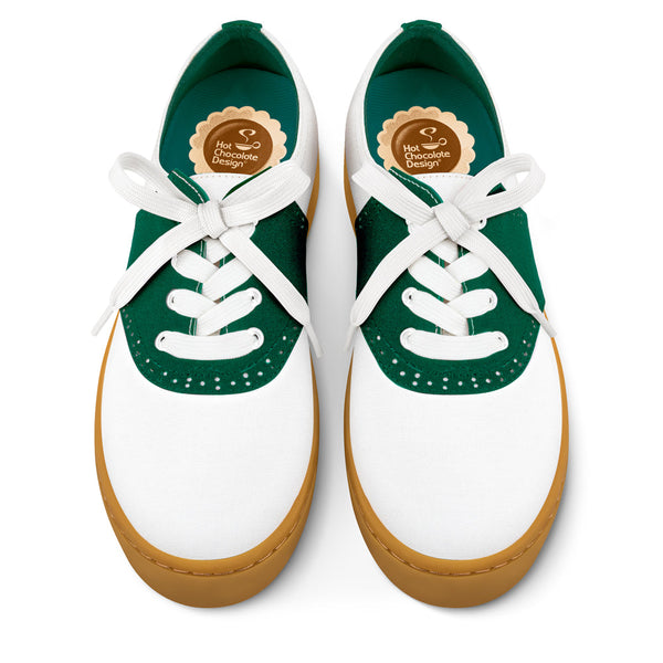 Hot Chocolate Design White sneakers with green accents and brown soles on a white background