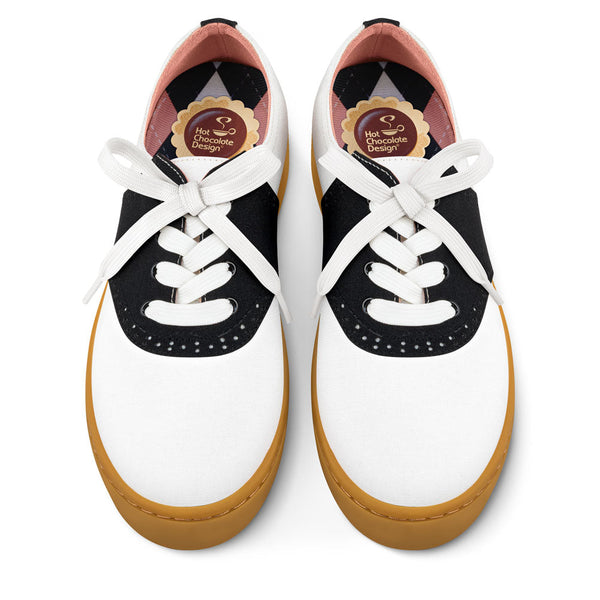 Hot Chocolate Design Pair of white sneakers with black accents and brown soles on a white background