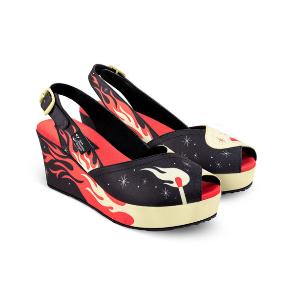 Wedge sandals with flame design on a white background