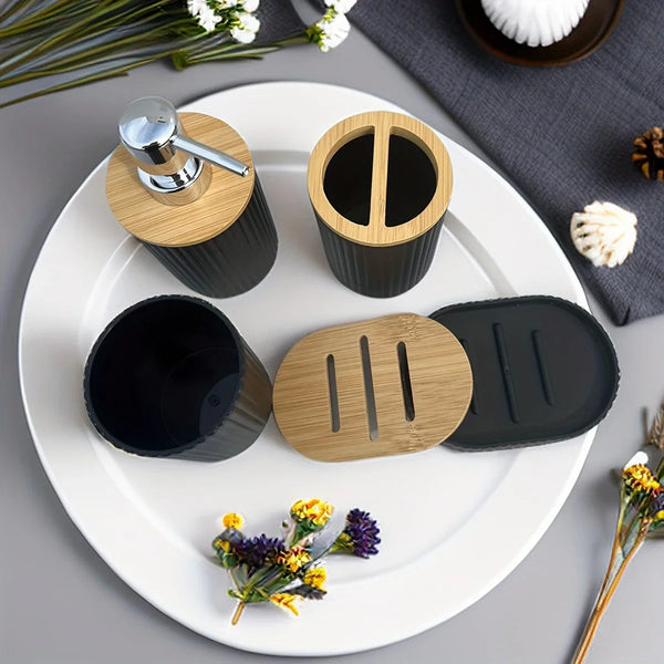Top view of Buddify black bathroom accessories set with bamboo lids and ribbed design, arranged on a white plate with decorative flowers.