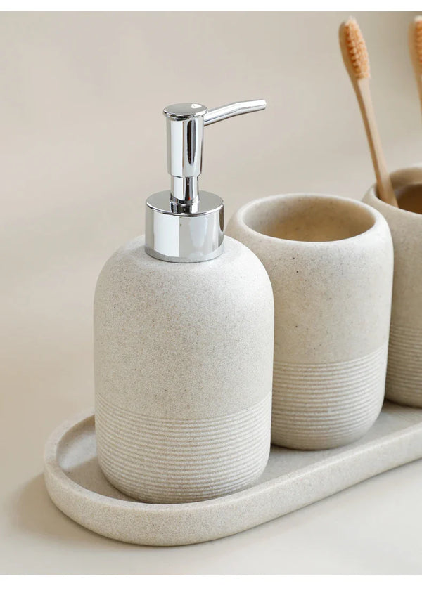 Close-up of beige soap dispenser with chrome pump from Buddify's 5Pcs Bathroom Accessories set, placed on coordinating tray.