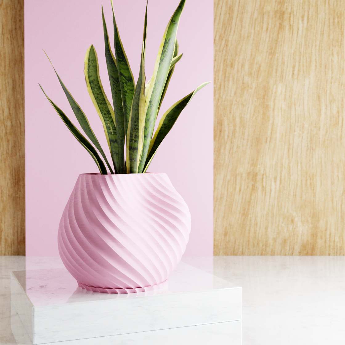 Pink vase with a plant on a white surface against a pink background