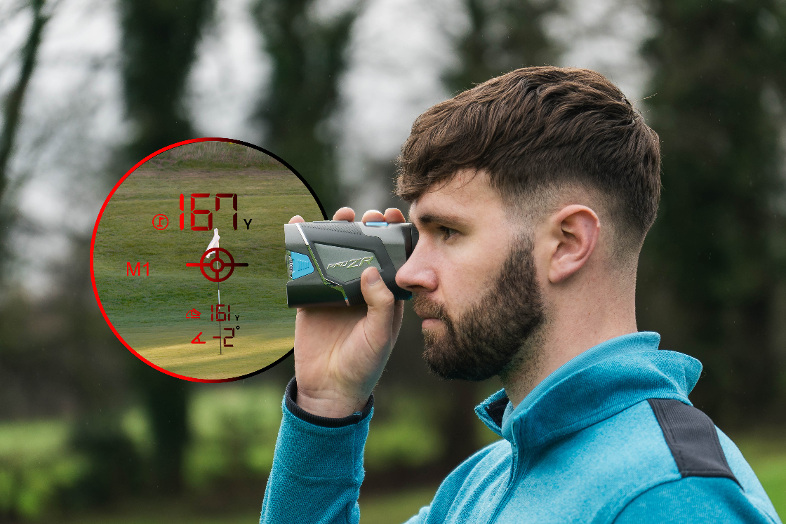 Man using a laser range finder in an outdoor setting