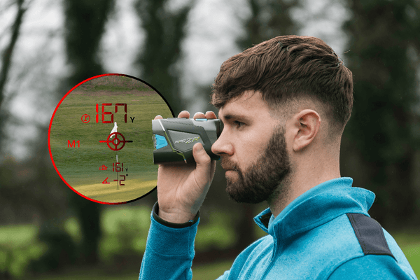 Man using a laser range finder in an outdoor setting