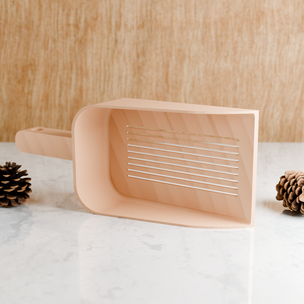 Wooden dustpan on a white surface with a wooden background