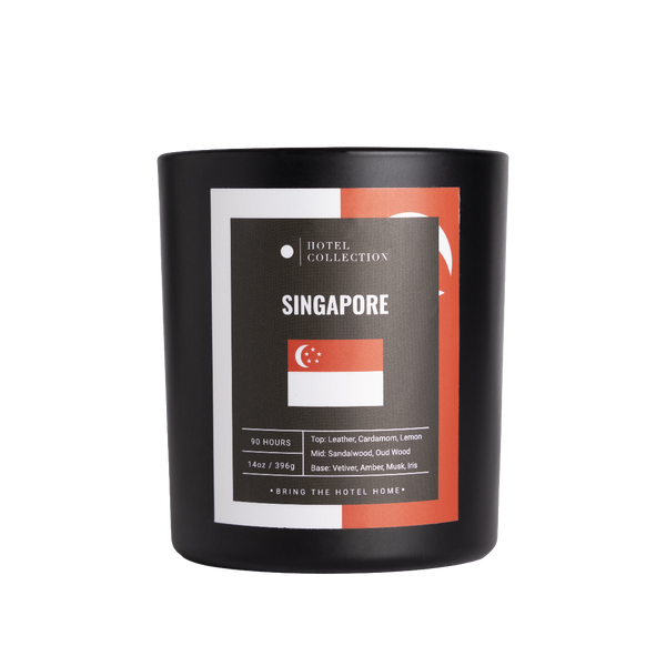 Black candle with Singapore-themed label on a white background