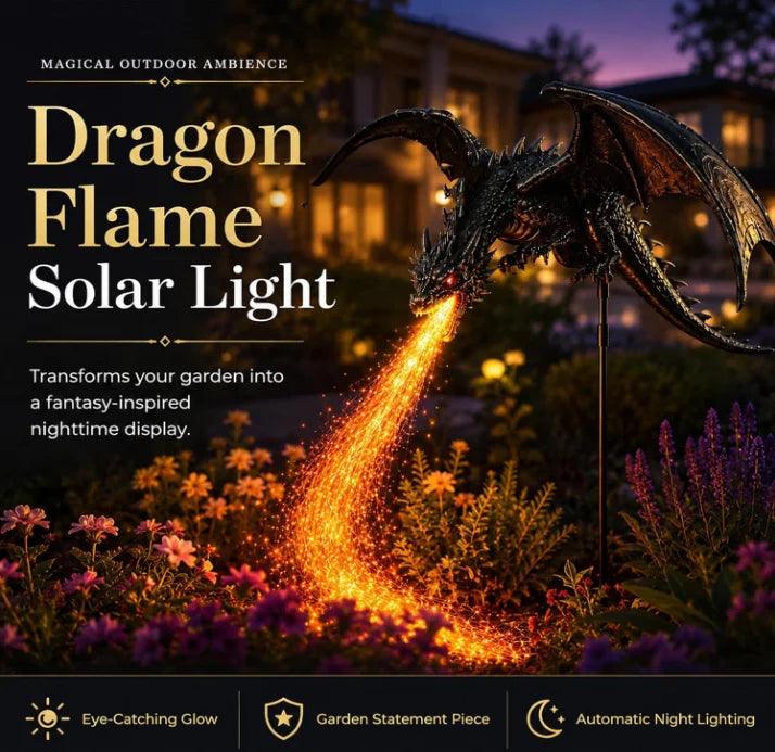 Dragon Flame Solar Light in a garden at night, breathing a stream of glowing orange embers. The dark metallic dragon statue is shown in a beautifully lit garden with flowers and a house in the background, with promotional text overlays.