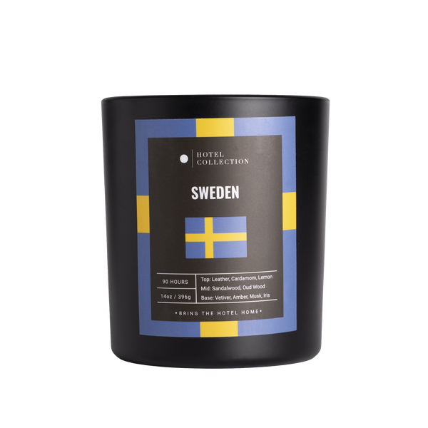 Black candle with Sweden-themed label on a white background