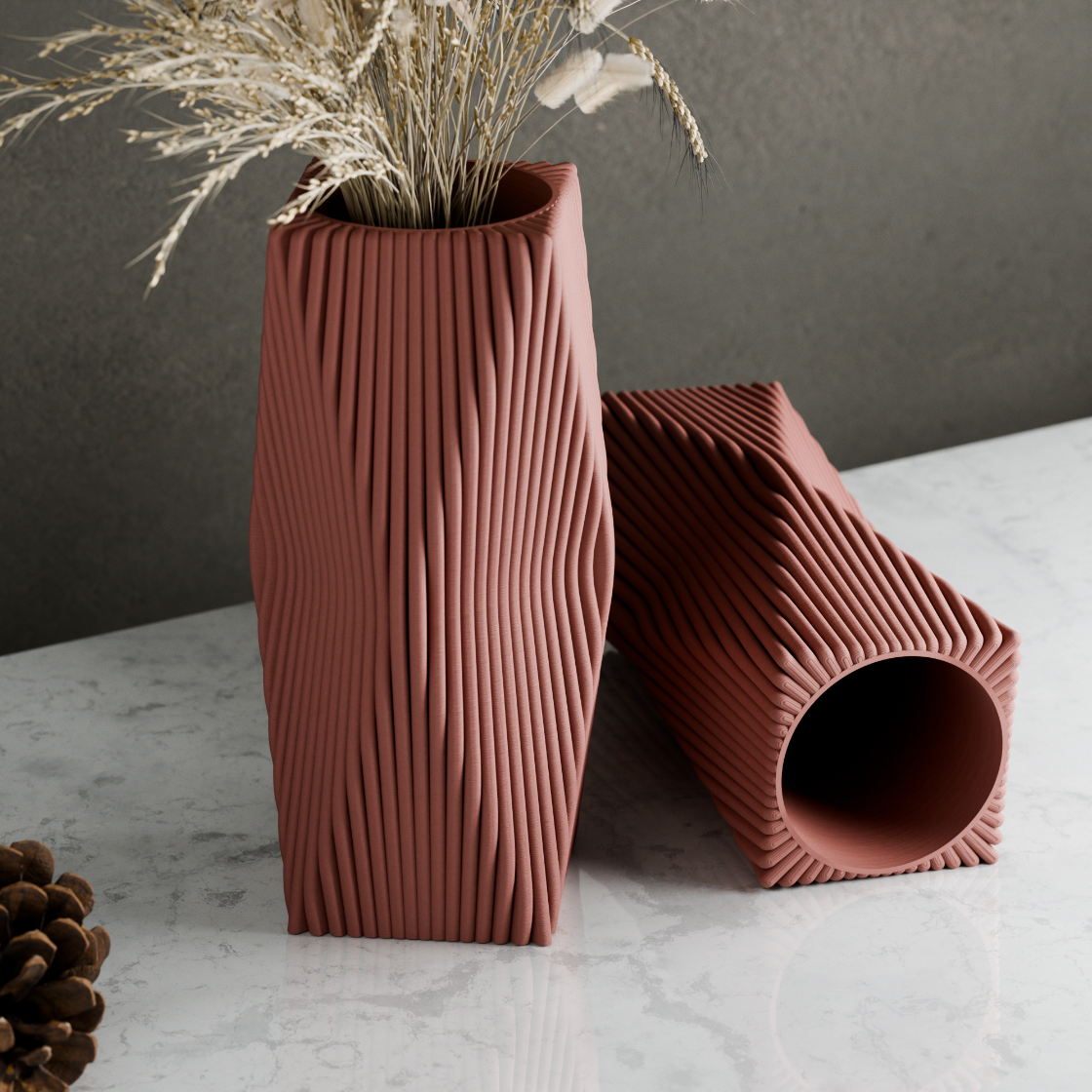 Two ribbed ceramic vases on a marble surface with a dark background
