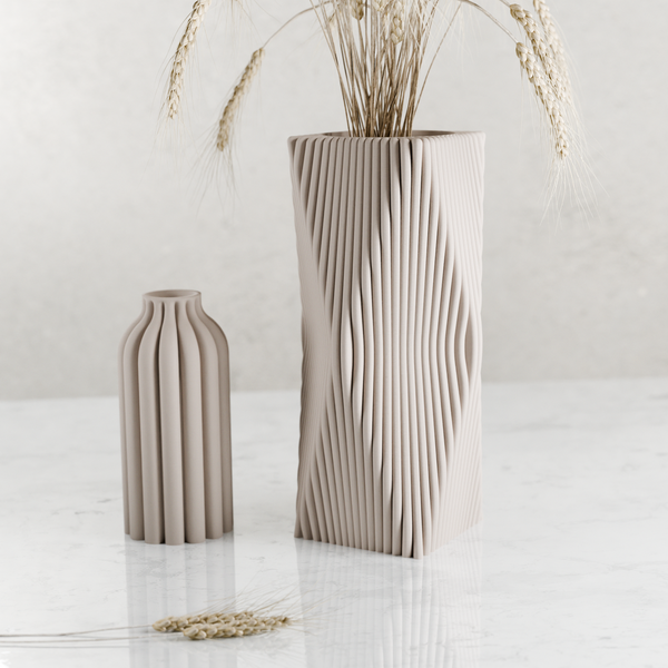 Two beige ceramic vases with textured surfaces on a light background