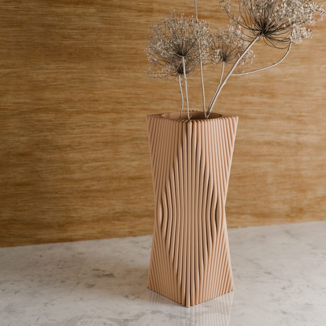 Beige textured vase with dried flowers against a wooden background