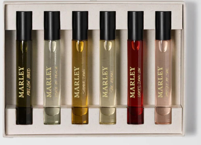 Travel Discovery Eaux De Parfam Set - Unisex by Bob Marley. Marley perfume bottles in a display case