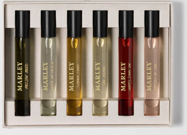 Travel Discovery Eaux De Parfam Set - Unisex by Bob Marley. Marley perfume bottles in a display case