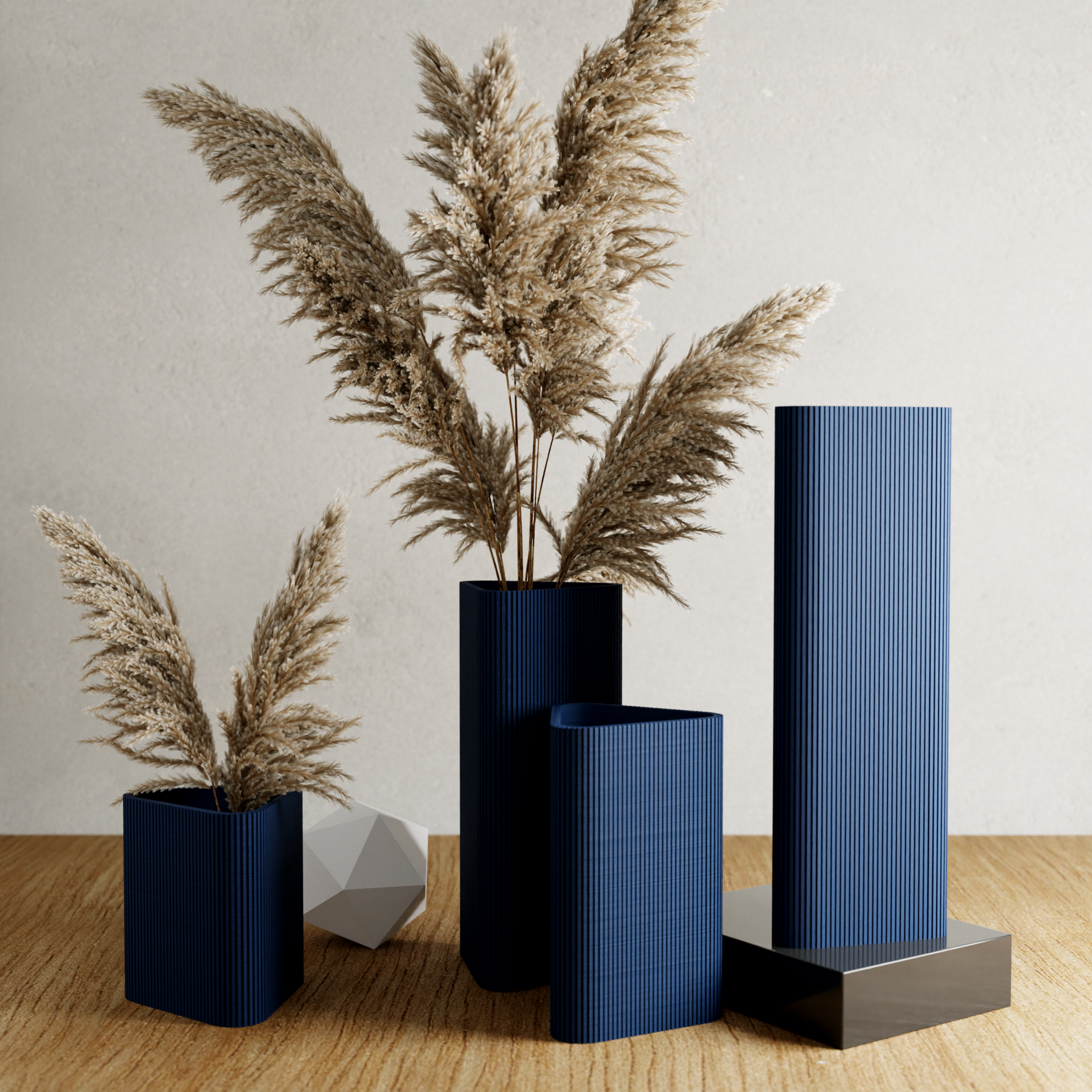 Set of blue vases with dried plants on a wooden surface