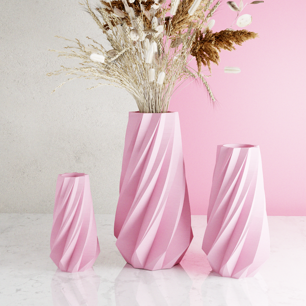 Set of pink vases with a textured surface on a light background