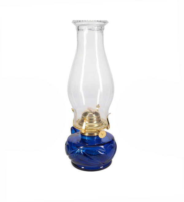 Kerosene lamp with blue base and clear glass chimney on a white background