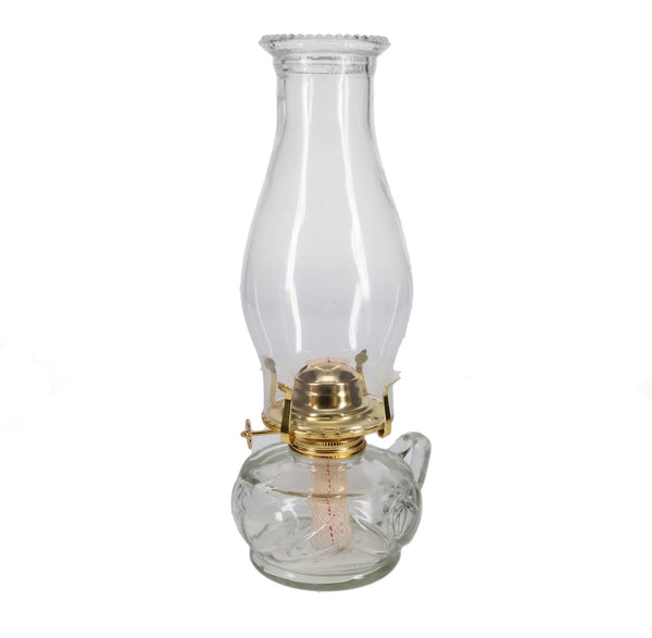 Clear glass oil lamp with brass base on a white background