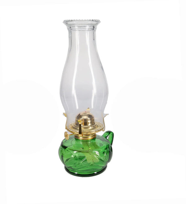Green oil lamp with clear glass chimney on a white background