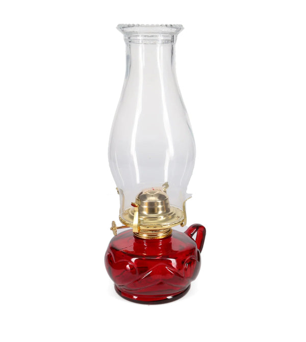 Red oil lamp with clear glass chimney on a white background