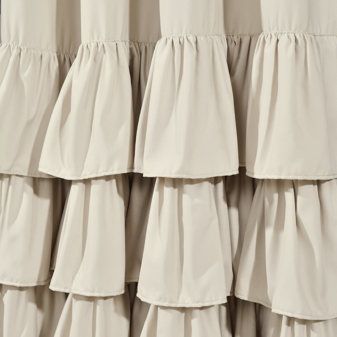 Close-up of beige ruffled curtains
