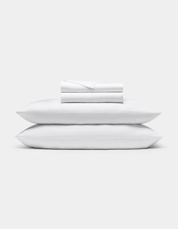 White bed sheets and pillowcases on a white background
