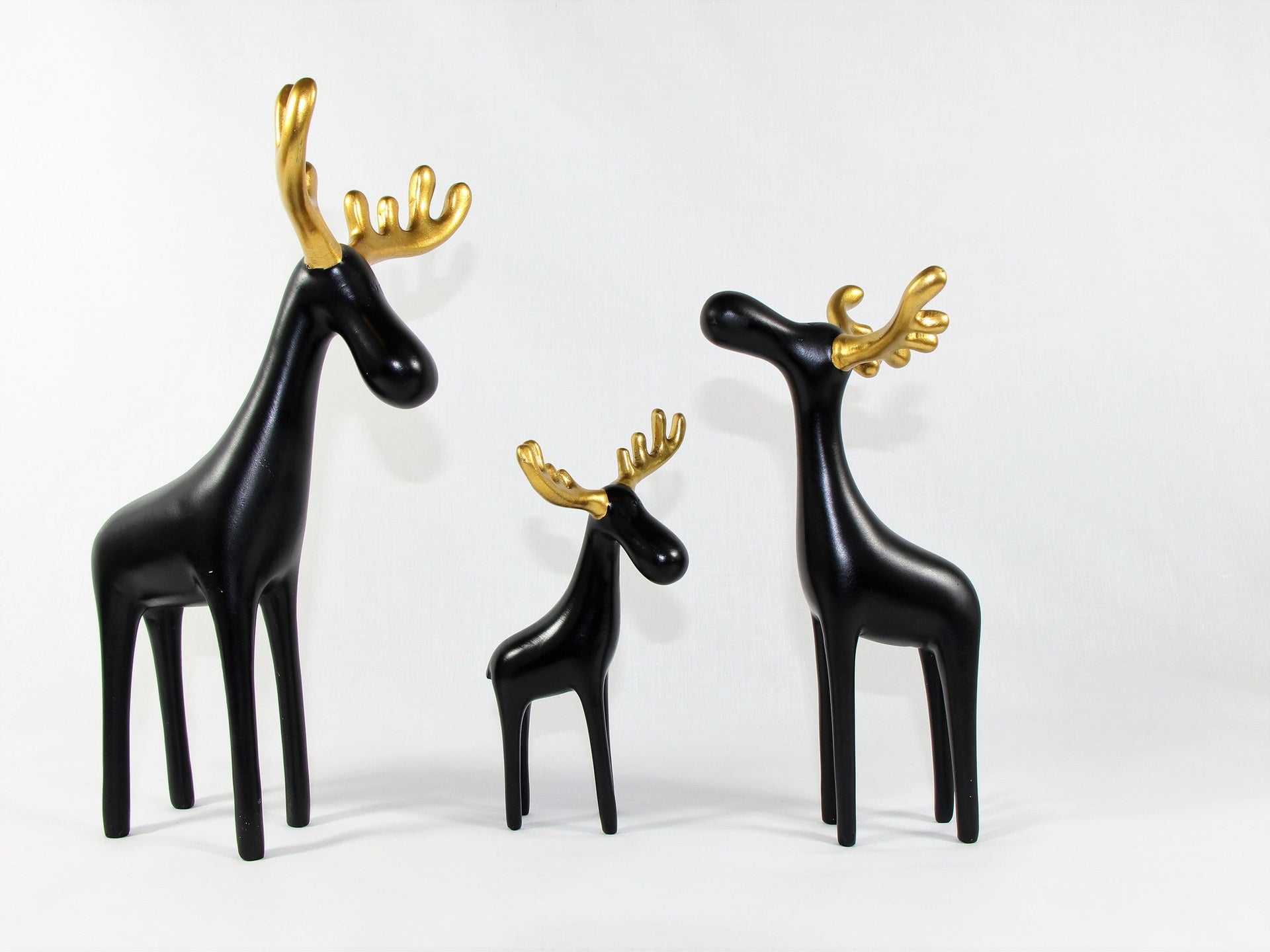 Family of Three Black Reindeer Sculptures with Golden Antlers