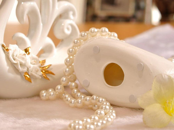 Pair of White Porcelain Swans with Decorative Wings