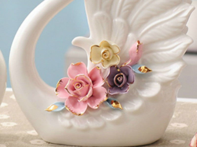 Pair of Porcelain Swans with an Arrangement of Pinched Multi-Color Roses