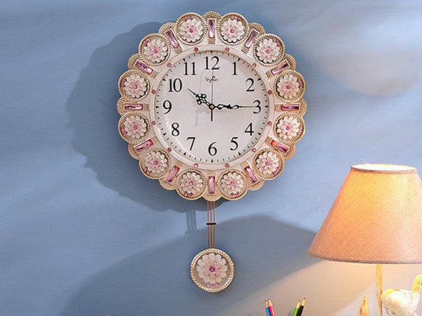 Metallic Gold Clock with Pendulum adorned with Pink Stone Accents