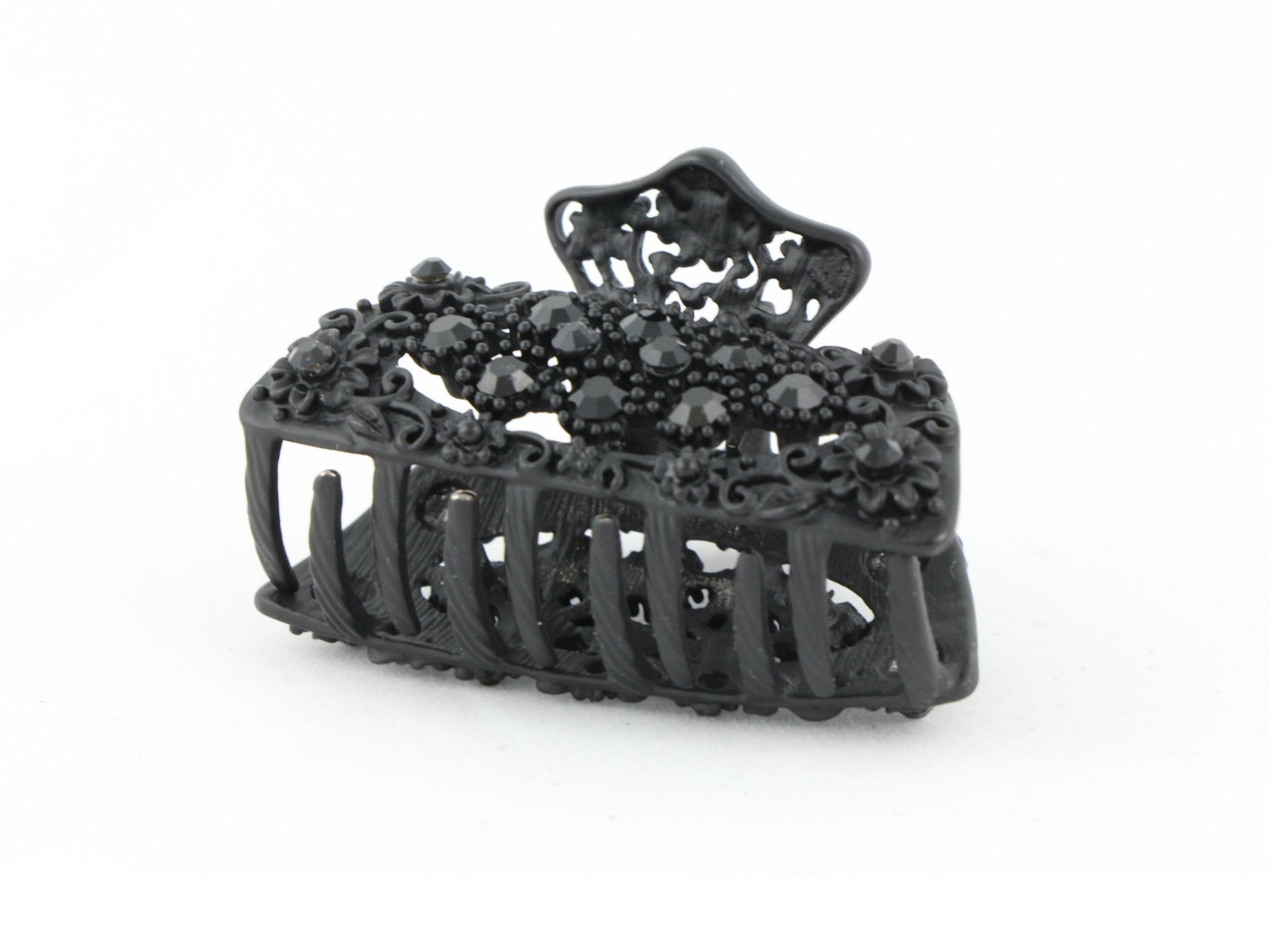 Black metal hair claw clip with black stones on a tiny floral pattern