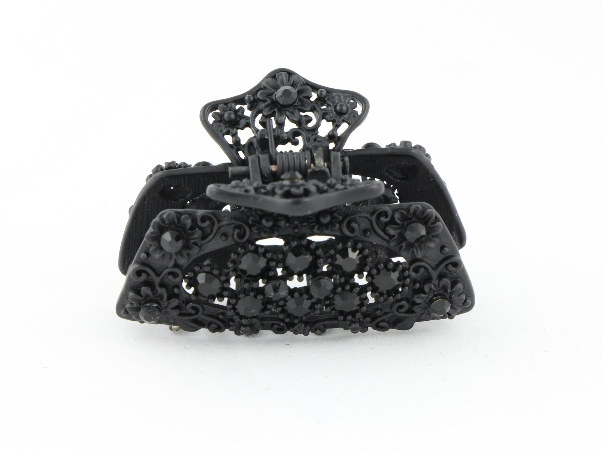 Black metal hair claw clip with black stones on a tiny floral pattern