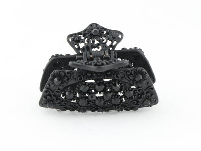 Black metal hair claw clip with black stones on a tiny floral pattern