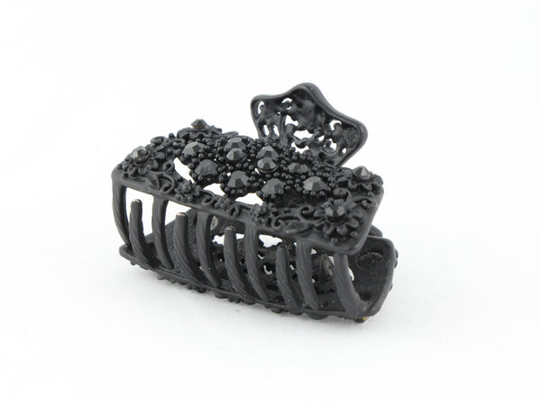 Black metal hair claw clip with black stones on a tiny floral pattern