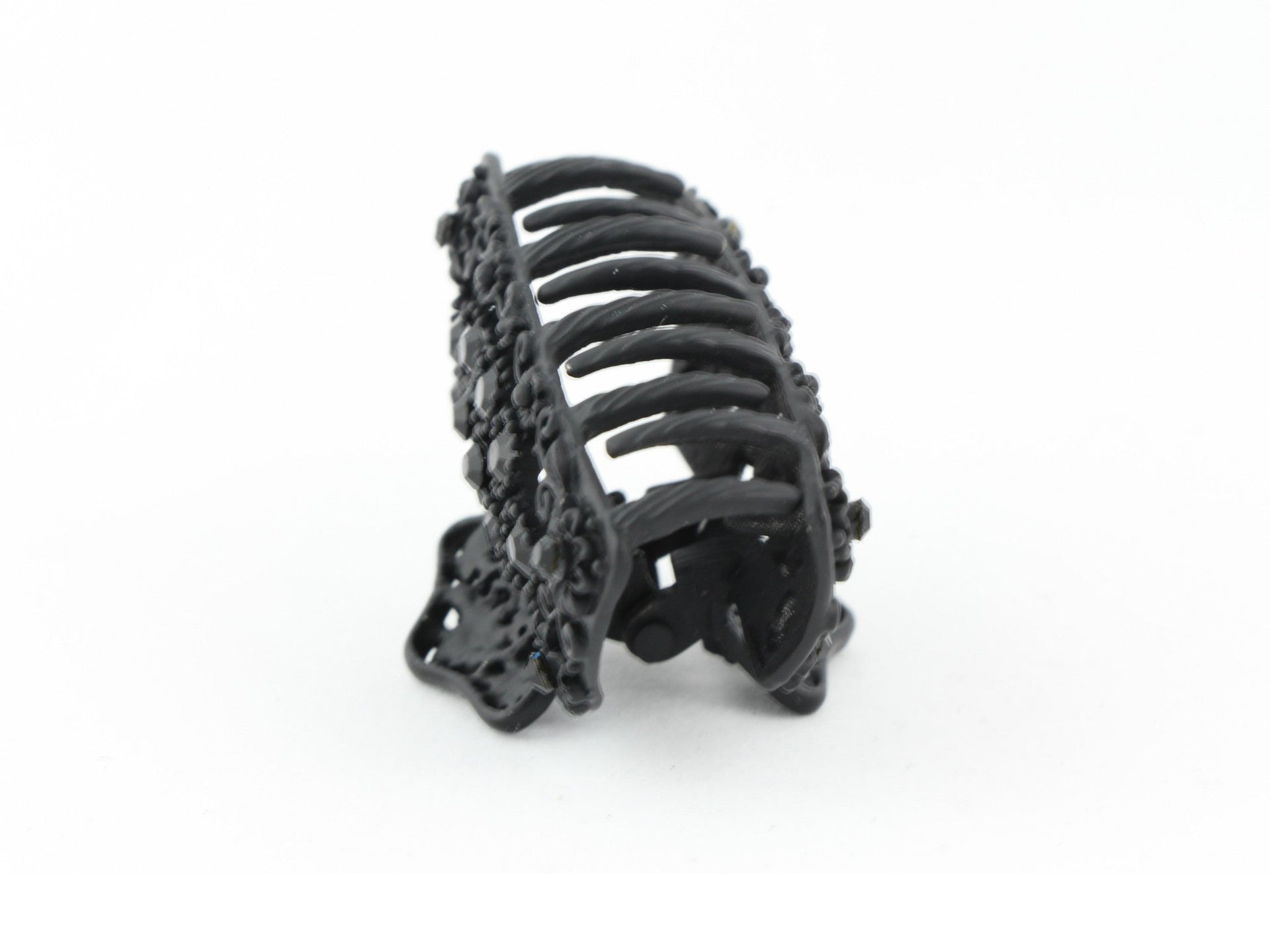 Black metal hair claw clip with black stones on a tiny floral pattern