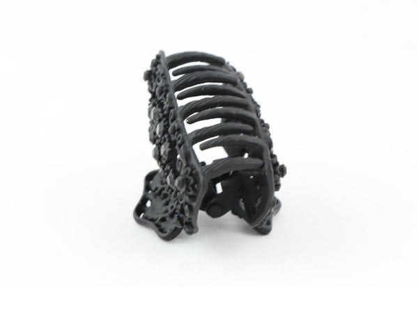 Black metal hair claw clip with black stones on a tiny floral pattern