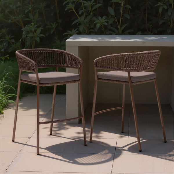 Zuo Skye Barstool (Set Of 2) Brown - Two wicker bar stools with cushioned seats in front of a white table outdoors.