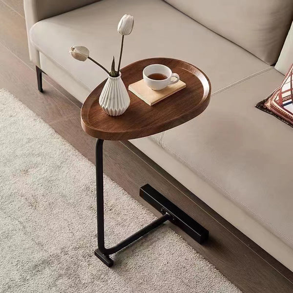 Brown C-shaped Side Table placed beside a beige sofa, showcasing its space-saving design and functionality for living room use.