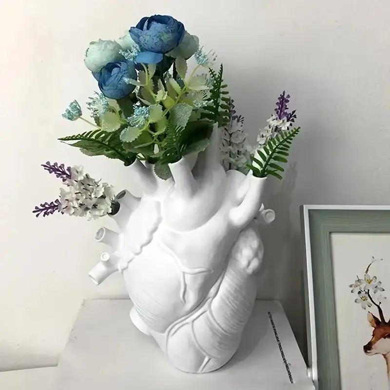 White anatomical heart vase with colorful flowers for living room