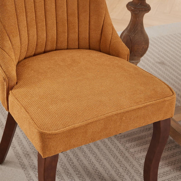 Close-up of the cushioned seat of the Set of 2 Rayon Cloth Flocking Linen Dining Chairs showing textured mustard yellow fabric.
