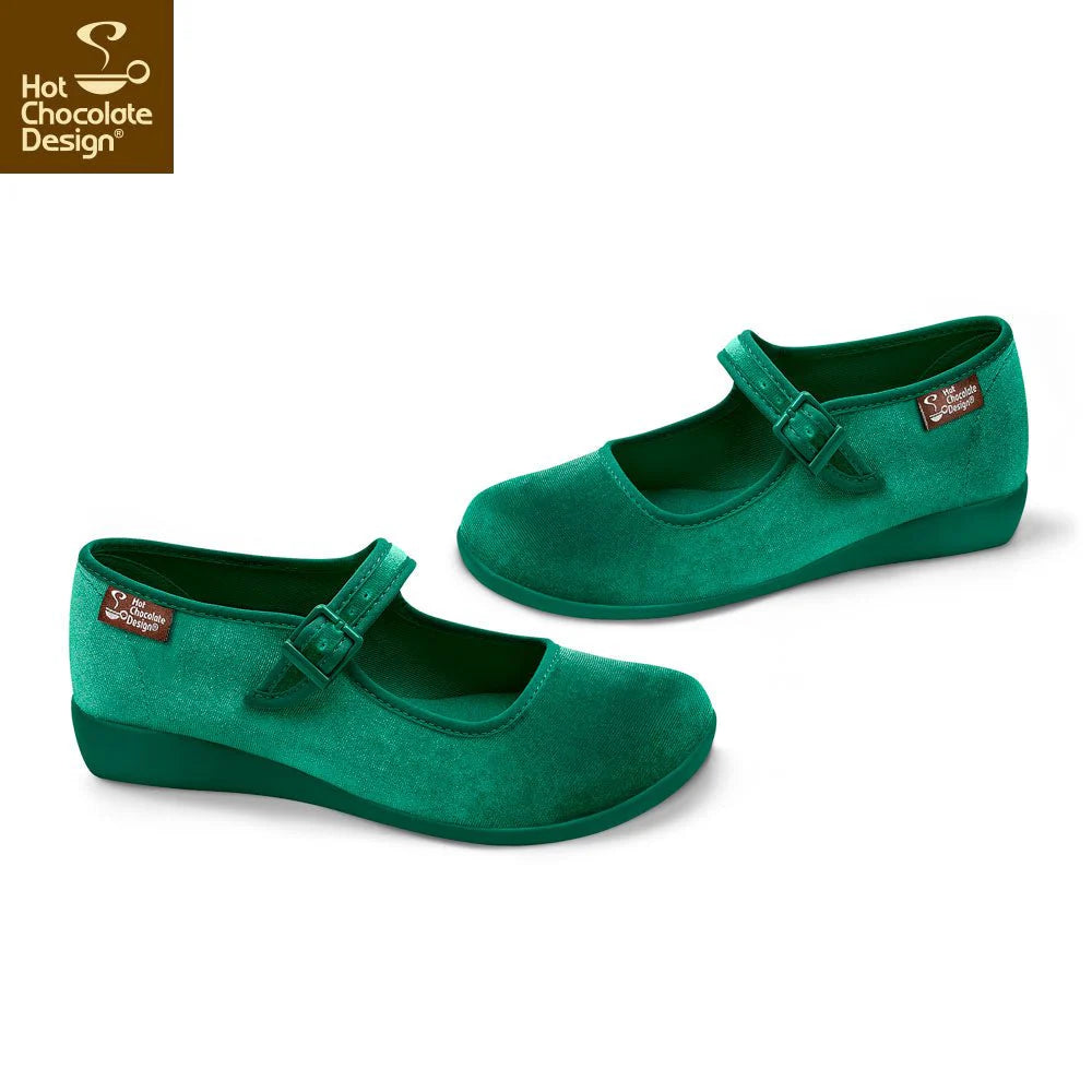 Green shoes with a strap on a white background, featuring Hot Chocolate Design logo.
