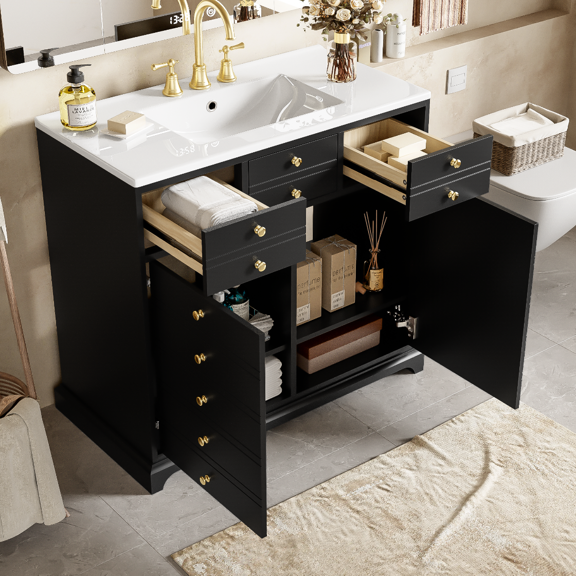 Bathroom vanity with open drawers and a sink, featuring gold fixtures.