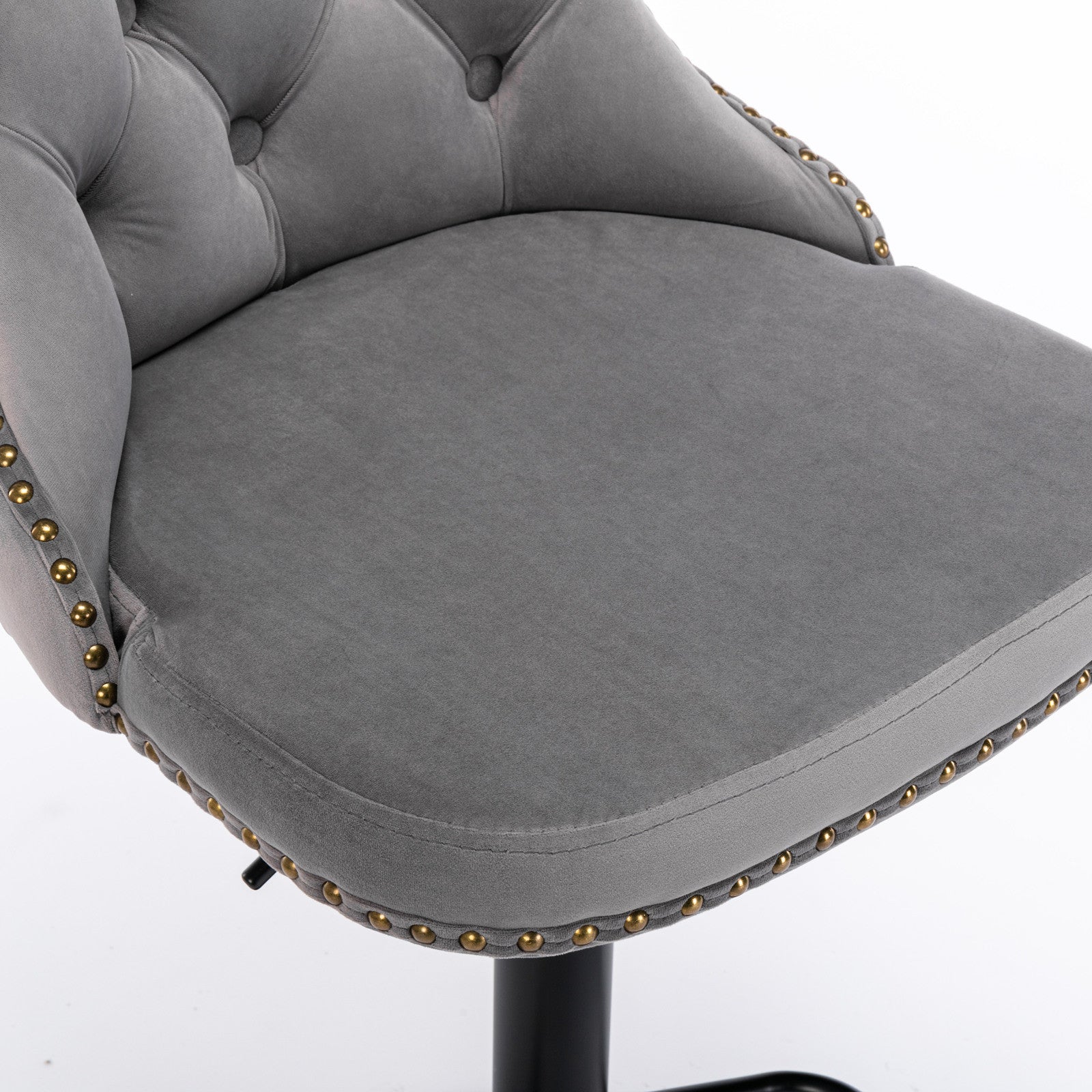 Close-up of grey velvet seat cushion with gold nailhead trim on Swivel Velvet Barstool, highlighting plush comfort and premium finish.