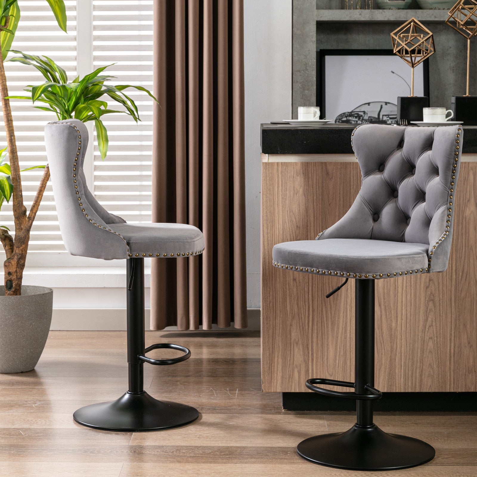 Set of 2 Swivel Velvet Barstools in a modern kitchen, showcasing grey tufted upholstery and black adjustable bases for stylish seating.