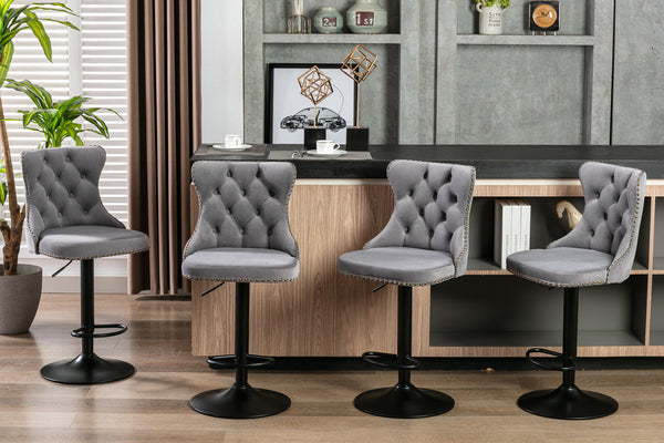 Set of 4 Swivel Velvet Barstools arranged at a kitchen counter, featuring grey tufted upholstery and black pedestal bases for modern decor.